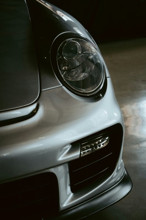 the front end of a silver sports car