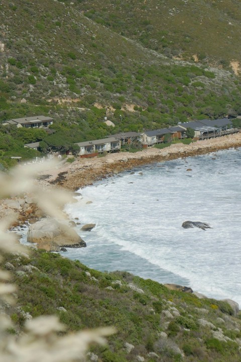 a view of a beach with houses and a body of water