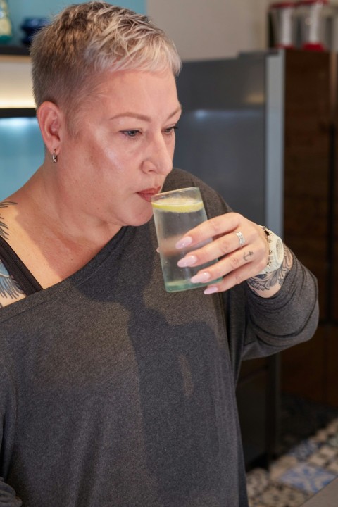 a person enjoying a glass of water