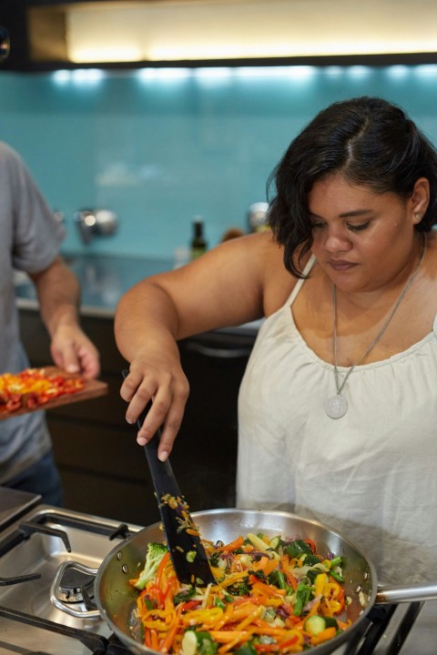 a woman preparing food in a kitchen