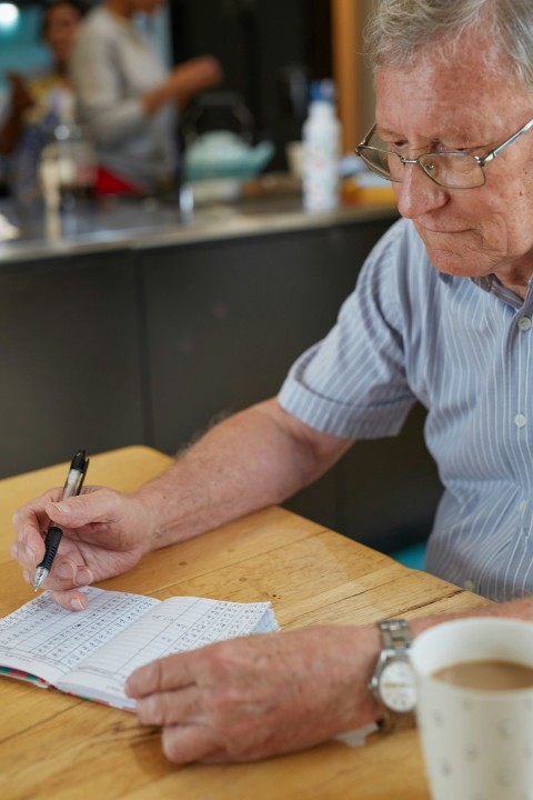 a person writing down blood glucose results