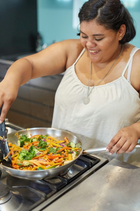 a woman preparing food on a stove