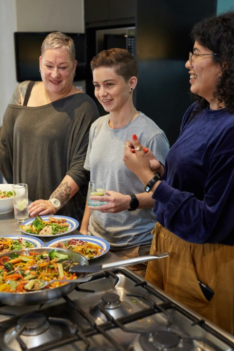 a group of people preparing food in a kitchen