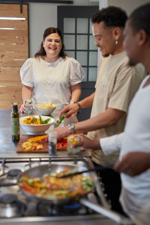 a group of people preparing food in a kitchen