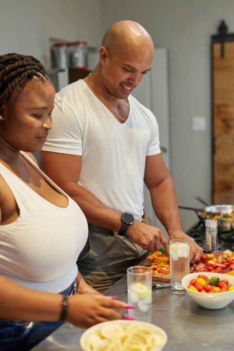 a group of people preparing food in a kitchen