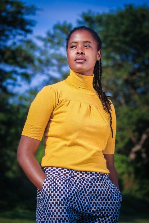 woman in yellow crew neck t shirt and black and white polka dot skirt