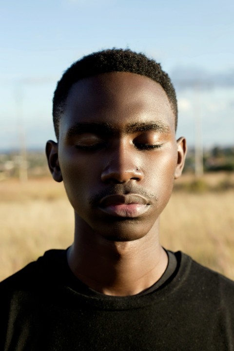 selective focus photography of man closing his eyes