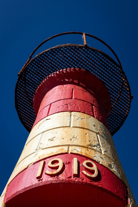 a red and yellow tower with a clock on it