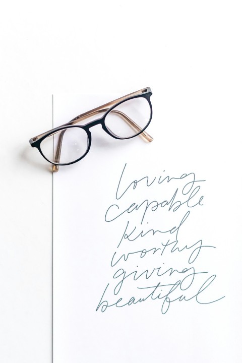 brown framed eyeglasses on white surface