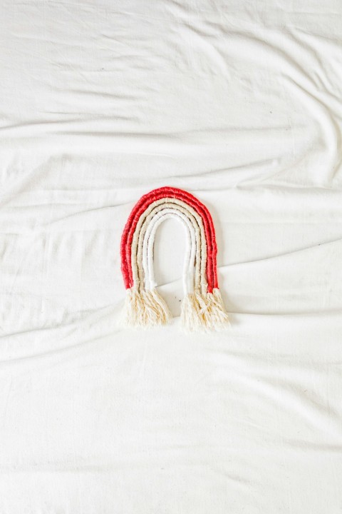 red and gold bracelet on white textile