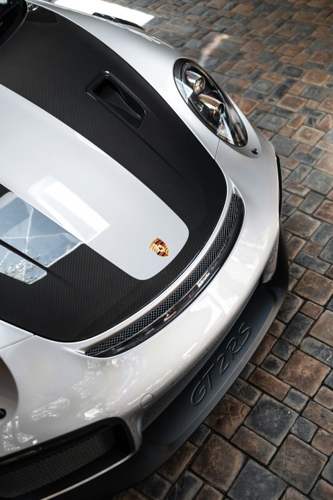 a white and black sports car parked on a brick road