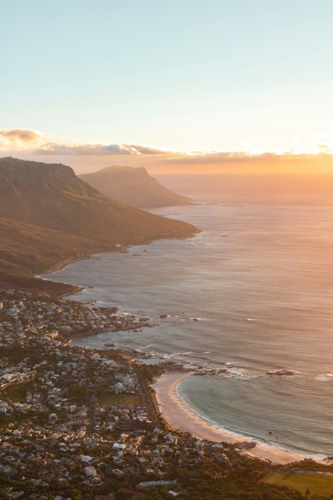 aerial view of city near body of water during sunset