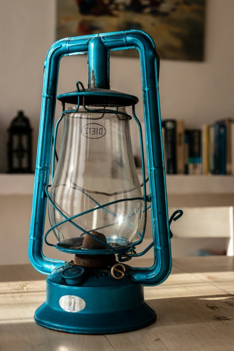 a blue lantern sitting on top of a wooden table