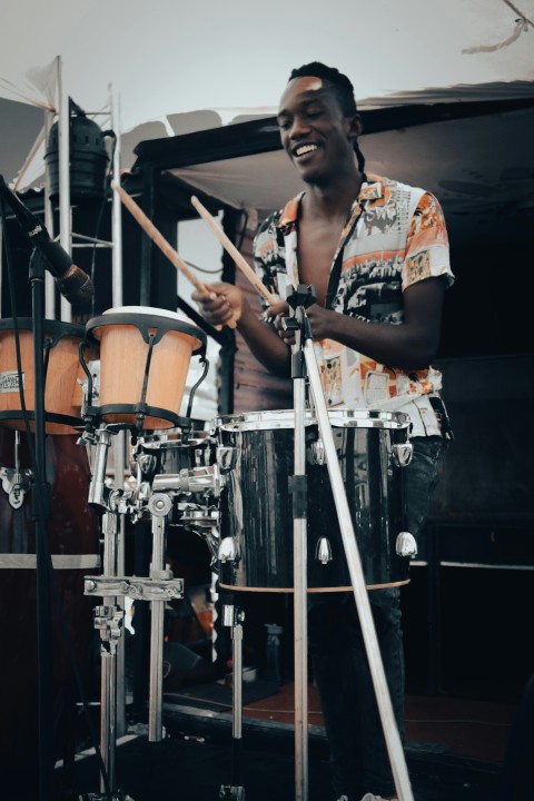 a man is playing drums on a stage