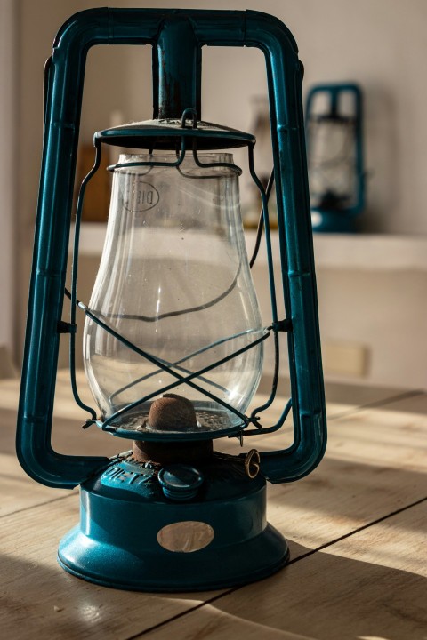 a blue lantern sitting on top of a wooden table