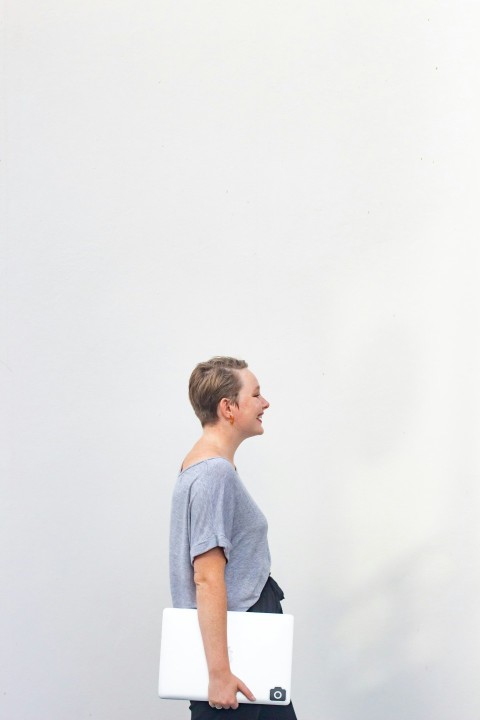 boy in blue crew neck t shirt standing near white wall