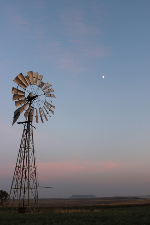 a windmill with a half moon in the background QVREW