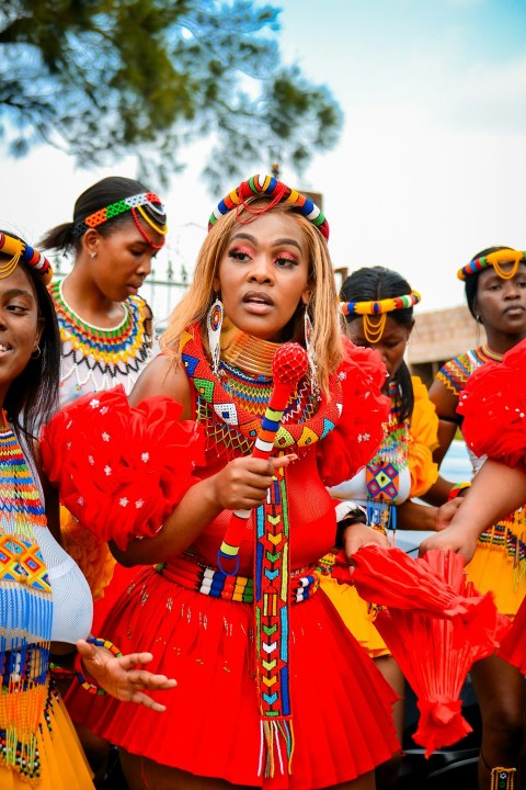 a group of women dressed in red and yellow