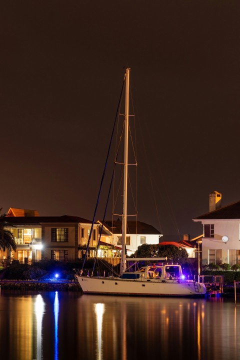 white and blue boat on dock during night time tfGU