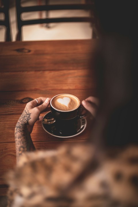 person holding black ceramic mug with coffee WcZUbC