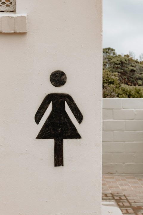 a black and white sign on a white wall