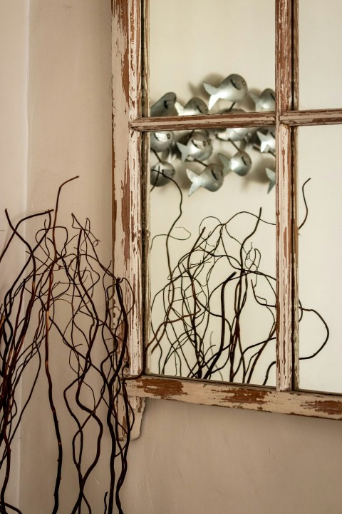 a window with a bunch of branches in front of it