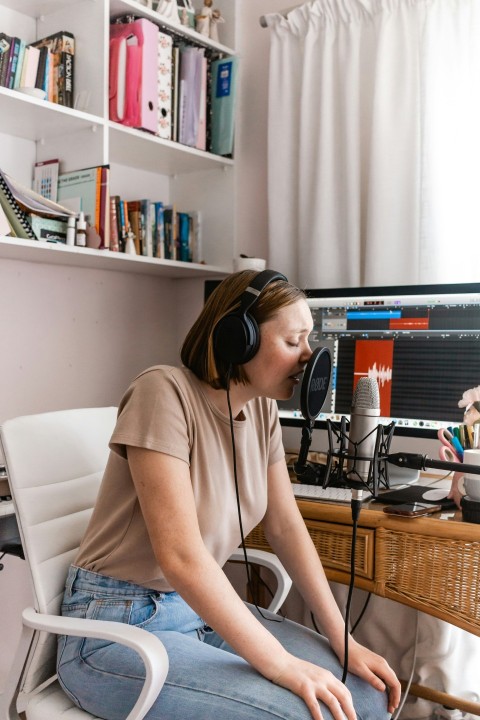 woman in brown shirt and blue denim jeans sitting on white chair FC