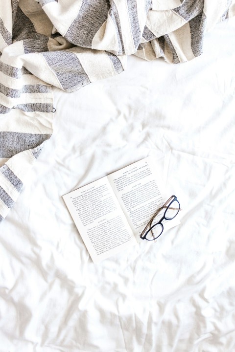 black framed eyeglasses on white textile