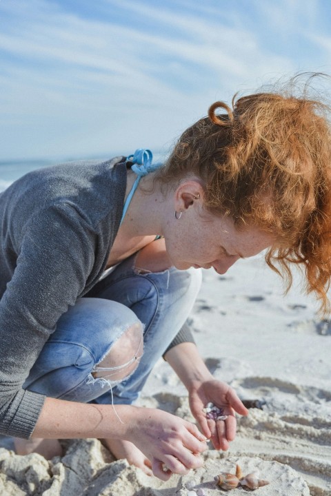 woman picking up shells