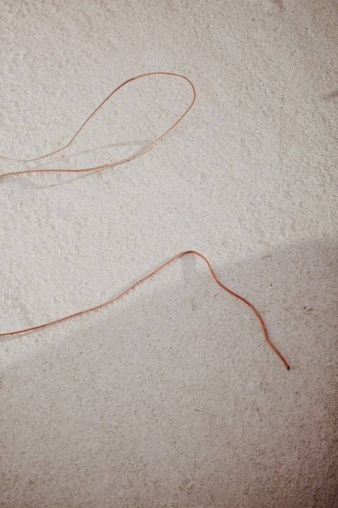 orange coated wire on white textile tYuz