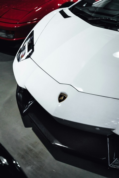 white porsche 911 parked on parking lot during daytime