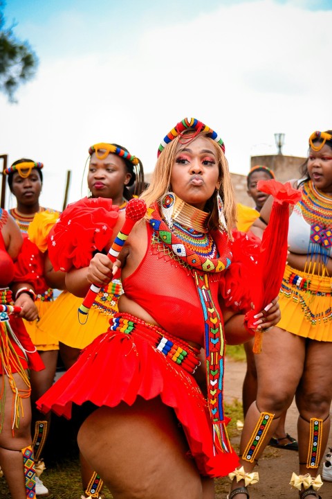 a group of women dressed in red and yellow