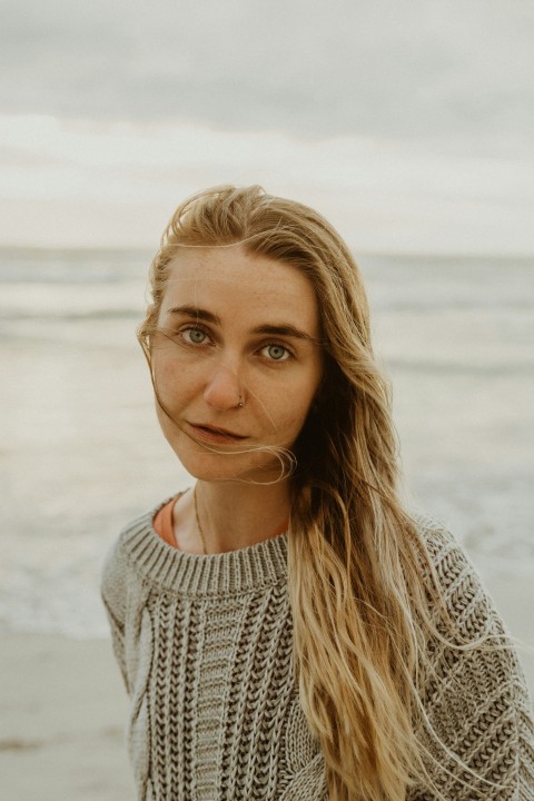 woman in white knit sweater smiling