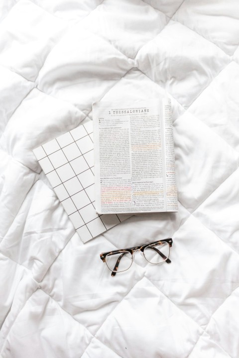 black framed eyeglasses on white textile