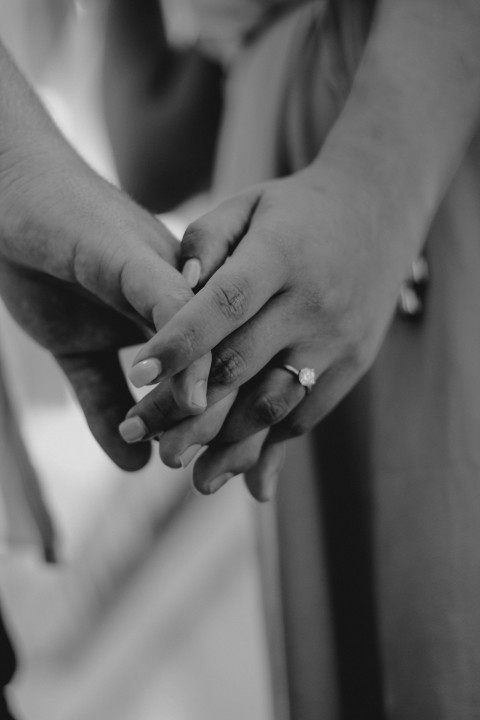 a close up of two people holding hands