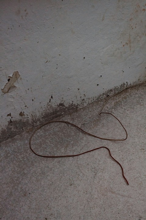 brown coated wire on white concrete wall