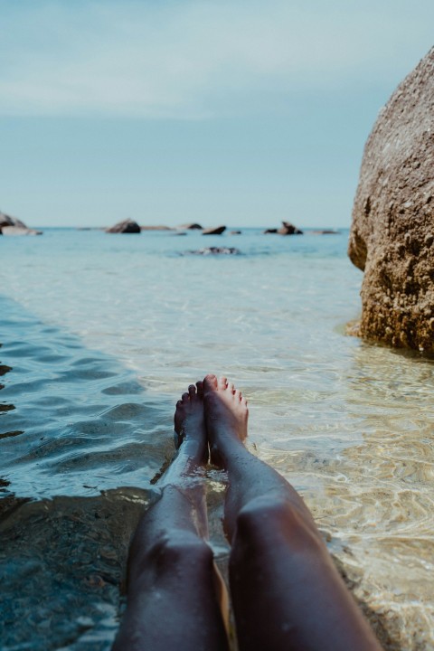 a persons feet sticking out of the water