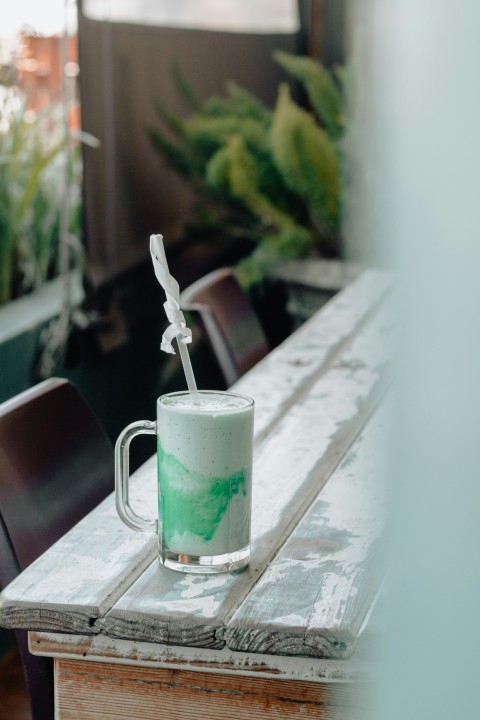 clear glass mug with green liquid