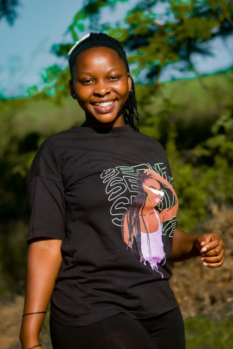 a woman in a black shirt is smiling