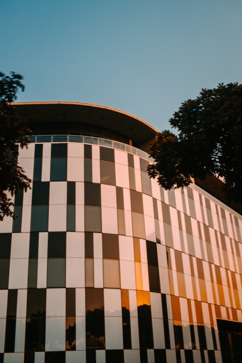 brown concrete building near green trees during daytime