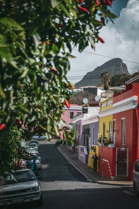 man beside red painted house