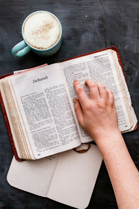 person holding white book page