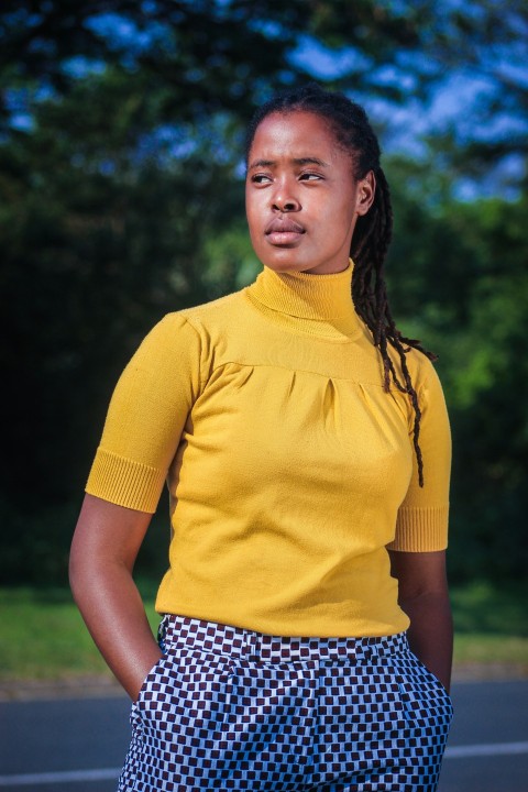 woman in yellow crew neck t shirt and black and white polka dot skirt