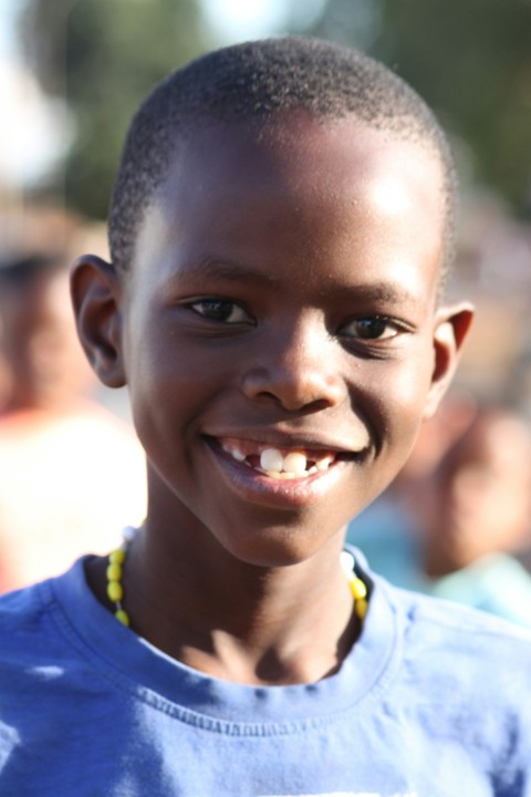 a close up of a boy smiling