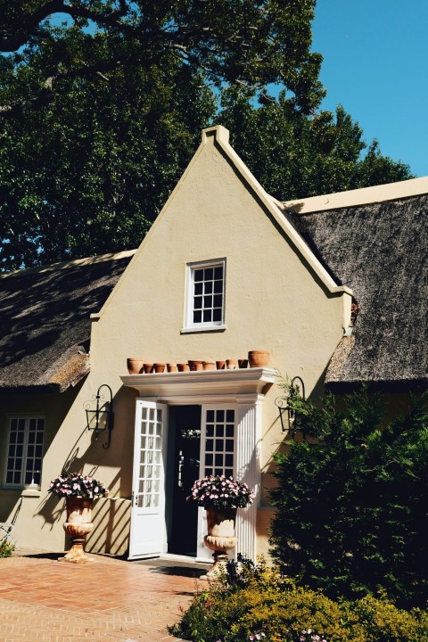 a house with a thatched roof and a white door