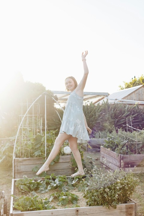 girl in white dress standing on brown wooden stairs during daytime