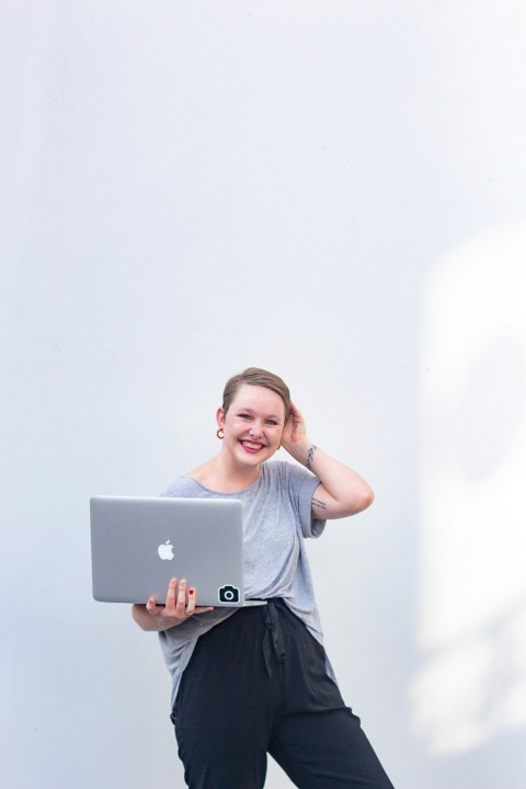 woman in gray crew neck t shirt holding silver ipad