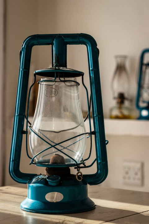 a blue lantern sitting on top of a wooden table