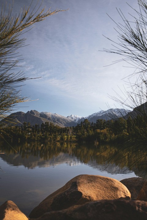 brown and white mountains near body of water during daytime