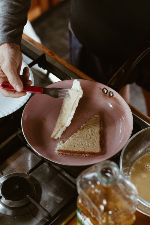 person holding brown bread on blue ceramic plate zENnE